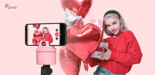 Creator filming a Valentine’s Day video with a pink Pivo Pod and heart-shaped balloons