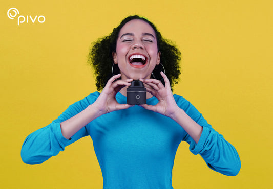 Creator holding a Pivo Pod Silver against a yellow background
