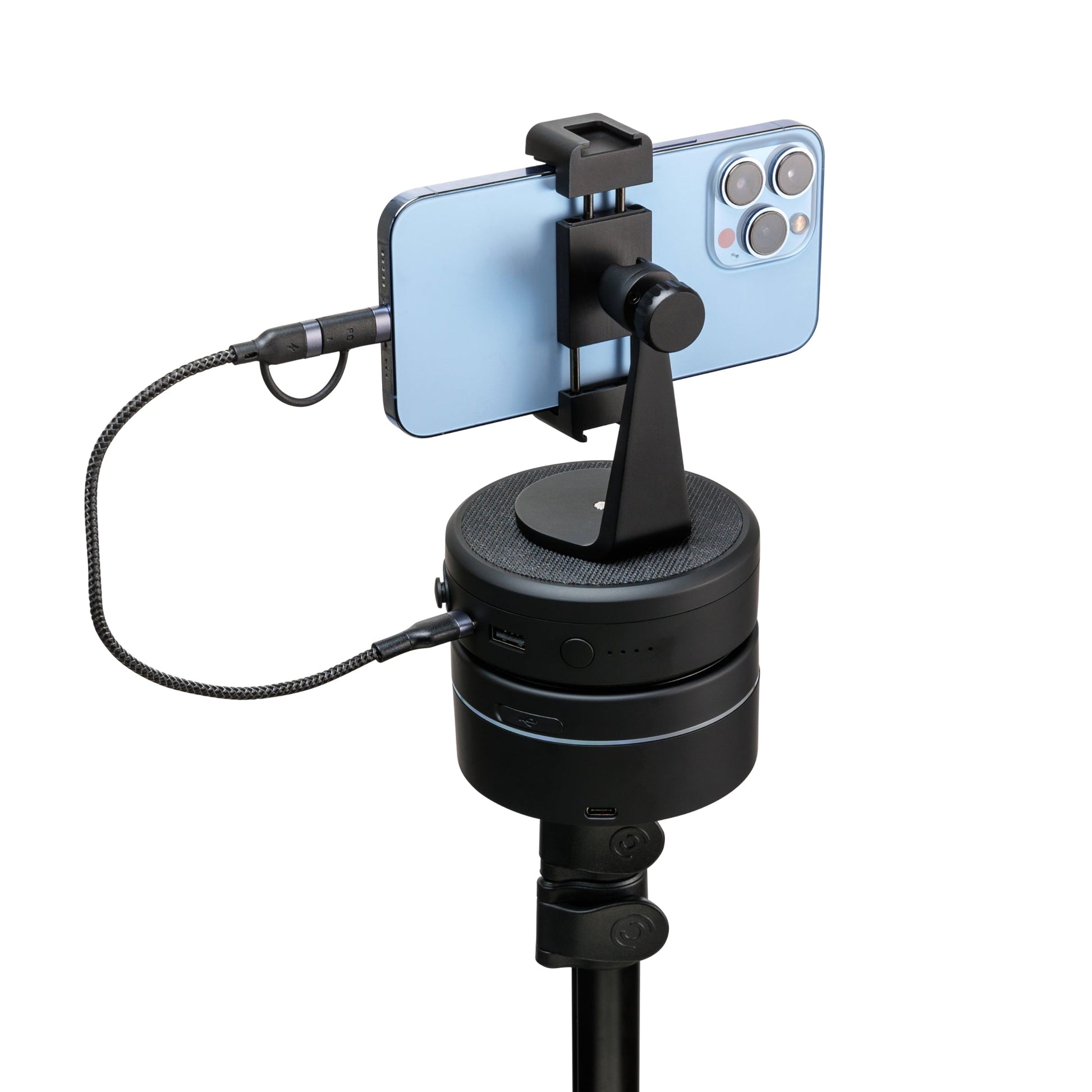 Portable power bank fast charger with dual USB ports charging a smartphone on a stand